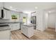 Contemporary kitchen featuring white cabinets, a granite island, and stainless steel appliances at 443 Faith Sw Dr, Concord, NC 28027