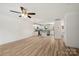 Open living room with hardwood floors flows seamlessly into the kitchen with white cabinetry at 443 Faith Sw Dr, Concord, NC 28027