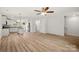 Bright open floor plan with hardwood floors and white walls leading to the kitchen and stairs at 443 Faith Sw Dr, Concord, NC 28027