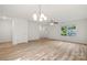 Open-concept living room, hardwood floors, and ample natural light at 445 Faith Sw Dr, Concord, NC 28027