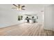 Bright, open-concept living room with hardwood floors, ceiling fan, and ample natural light at 445 Faith Sw Dr, Concord, NC 28027
