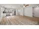Open-concept living room boasts hardwood floors, and access to kitchen and staircase at 445 Faith Sw Dr, Concord, NC 28027
