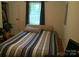 Bedroom with blue striped bedspread and curtains, with a window at 448 Belk St, Lancaster, SC 29720