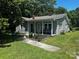 Charming home featuring a cozy front porch and a well-maintained, green lawn at 448 Belk St, Lancaster, SC 29720