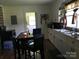View of kitchen with white cabinets, stainless steel sink, and dining table at 448 Belk St, Lancaster, SC 29720