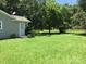 Well-maintained yard with lush lawn, mature trees and convenient side door access to home at 448 Belk St, Lancaster, SC 29720