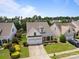Aerial view of a charming home with a well-manicured lawn, landscaping, and a two-car garage at 5238 Prosperity View Dr, Charlotte, NC 28269