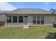 Well-maintained backyard with green lawn and a view of the home's exterior and windows at 5238 Prosperity View Dr, Charlotte, NC 28269