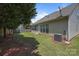 Well-maintained backyard featuring lush greenery and privacy, alongside the home's exterior at 5238 Prosperity View Dr, Charlotte, NC 28269