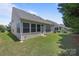 Well-maintained backyard with green lawn and a view of the home's exterior and windows at 5238 Prosperity View Dr, Charlotte, NC 28269