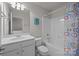 Bright bathroom showcasing a white vanity, toilet, and tub with colorful shower curtain at 5238 Prosperity View Dr, Charlotte, NC 28269