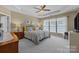 Bright bedroom features large windows, neutral walls, tray ceiling, and ceiling fan at 5238 Prosperity View Dr, Charlotte, NC 28269