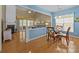 Bright dining area with a glass table, wooden chairs, and a view into the living room at 5238 Prosperity View Dr, Charlotte, NC 28269