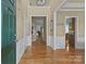 Elegant foyer featuring hardwood floors, wainscoting, and an open view into other rooms at 5238 Prosperity View Dr, Charlotte, NC 28269