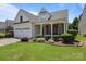 Beautiful home with a two-car garage, complemented by lush landscaping and a well-kept lawn at 5238 Prosperity View Dr, Charlotte, NC 28269