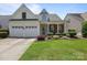 Inviting home boasts a two-car garage, manicured lawn, and a welcoming front porch at 5238 Prosperity View Dr, Charlotte, NC 28269