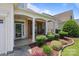 Charming front porch featuring brick accents, white columns, and meticulous landscaping at 5238 Prosperity View Dr, Charlotte, NC 28269