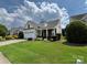 Charming home with a well-manicured lawn, a two-car garage, and lovely landscaping at 5238 Prosperity View Dr, Charlotte, NC 28269