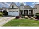 Well-maintained house with a two-car garage, a manicured lawn, and tasteful landscaping at 5238 Prosperity View Dr, Charlotte, NC 28269