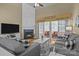 Cozy living room features a fireplace, hardwood floors, and sliding doors to the sunroom at 5238 Prosperity View Dr, Charlotte, NC 28269