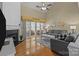 Spacious living room featuring hardwood floors, fireplace, and sliding doors to the sunroom at 5238 Prosperity View Dr, Charlotte, NC 28269