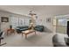 Cozy living room with a ceiling fan, carpet, sofas, and natural light from multiple windows at 5238 Prosperity View Dr, Charlotte, NC 28269