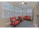 Relaxing sunroom with comfortable seating, ceiling fan, and abundant natural light at 5238 Prosperity View Dr, Charlotte, NC 28269