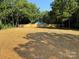 Expansive backyard featuring a new wooden fence, mature trees and a storage shed at 5306 Lee Massey Rd, Waxhaw, NC 28173