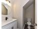 Charming half bath with modern vanity and fixtures and a neatly tucked toilet space at 5306 Lee Massey Rd, Waxhaw, NC 28173