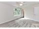 Neutral bedroom offers ample natural light, a ceiling fan, and plush carpeted flooring at 5306 Lee Massey Rd, Waxhaw, NC 28173