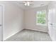 Bedroom features natural light, soft carpet, and a ceiling fan for added comfort at 5306 Lee Massey Rd, Waxhaw, NC 28173