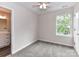Bright bedroom with neutral walls, carpet, a ceiling fan, and an ensuite bathroom visible from the room at 5306 Lee Massey Rd, Waxhaw, NC 28173
