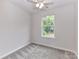 Bedroom features natural light, soft carpet, and a ceiling fan for added comfort at 5306 Lee Massey Rd, Waxhaw, NC 28173