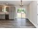 Dining area featuring modern lighting, sleek flooring, and sliding doors to the backyard, perfect for indoor-outdoor living at 5306 Lee Massey Rd, Waxhaw, NC 28173