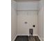 This laundry room features wood-look floors, wall shelving, and hookups for your washer and dryer at 5306 Lee Massey Rd, Waxhaw, NC 28173