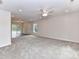 Open-concept living area with sliding glass doors, neutral carpet and recessed lighting, for easy access to the outdoors at 5306 Lee Massey Rd, Waxhaw, NC 28173
