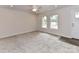 Spacious living room featuring plush carpeting, neutral tones, and natural light, providing a cozy and versatile living space at 5306 Lee Massey Rd, Waxhaw, NC 28173