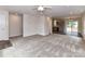 Expansive living space with sleek flooring and neutral carpeting, connecting the living, dining, and kitchen areas for open living at 5306 Lee Massey Rd, Waxhaw, NC 28173