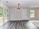 Bright living area features modern light fixture, access to backyard, and durable wood-style flooring at 5306 Lee Massey Rd, Waxhaw, NC 28173