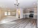 Open living space with neutral carpeting, sleek flooring, and a modern kitchen, ideal for entertaining and everyday living at 5306 Lee Massey Rd, Waxhaw, NC 28173