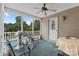 Cozy screened back porch with outdoor seating, table, and views of the backyard pool at 5563 Grace Chapel Rd, Hickory, NC 28601
