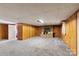 Basement featuring carpet, wood panel walls, drop ceiling, and a fireplace at 5563 Grace Chapel Rd, Hickory, NC 28601