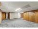 Spacious basement with carpeted floors and wood paneling, ideal for recreation or storage at 5563 Grace Chapel Rd, Hickory, NC 28601