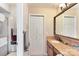 Bright bathroom with a single sink vanity featuring granite counters, and a shower and toilet in a separate room at 5563 Grace Chapel Rd, Hickory, NC 28601