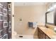Bathroom featuring a shower with a patterned curtain, towel racks, grab bar, and a single sink at 5563 Grace Chapel Rd, Hickory, NC 28601