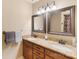 Bathroom showcasing double sink vanity with granite counters and framed mirrors with decorative lighting at 5563 Grace Chapel Rd, Hickory, NC 28601