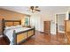 Cozy bedroom with hardwood floors, a ceiling fan, a double door closet, and a window with natural light at 5563 Grace Chapel Rd, Hickory, NC 28601