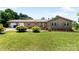Charming home featuring manicured lawn, stone accents, red shutters, and an attached two-car garage at 5563 Grace Chapel Rd, Hickory, NC 28601