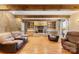 Open-concept living room features a stone fireplace and natural wood beams at 5563 Grace Chapel Rd, Hickory, NC 28601