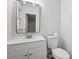 A modern bathroom with a white vanity, updated fixtures, and a matching toilet at 613 Davis St, Lancaster, SC 29720